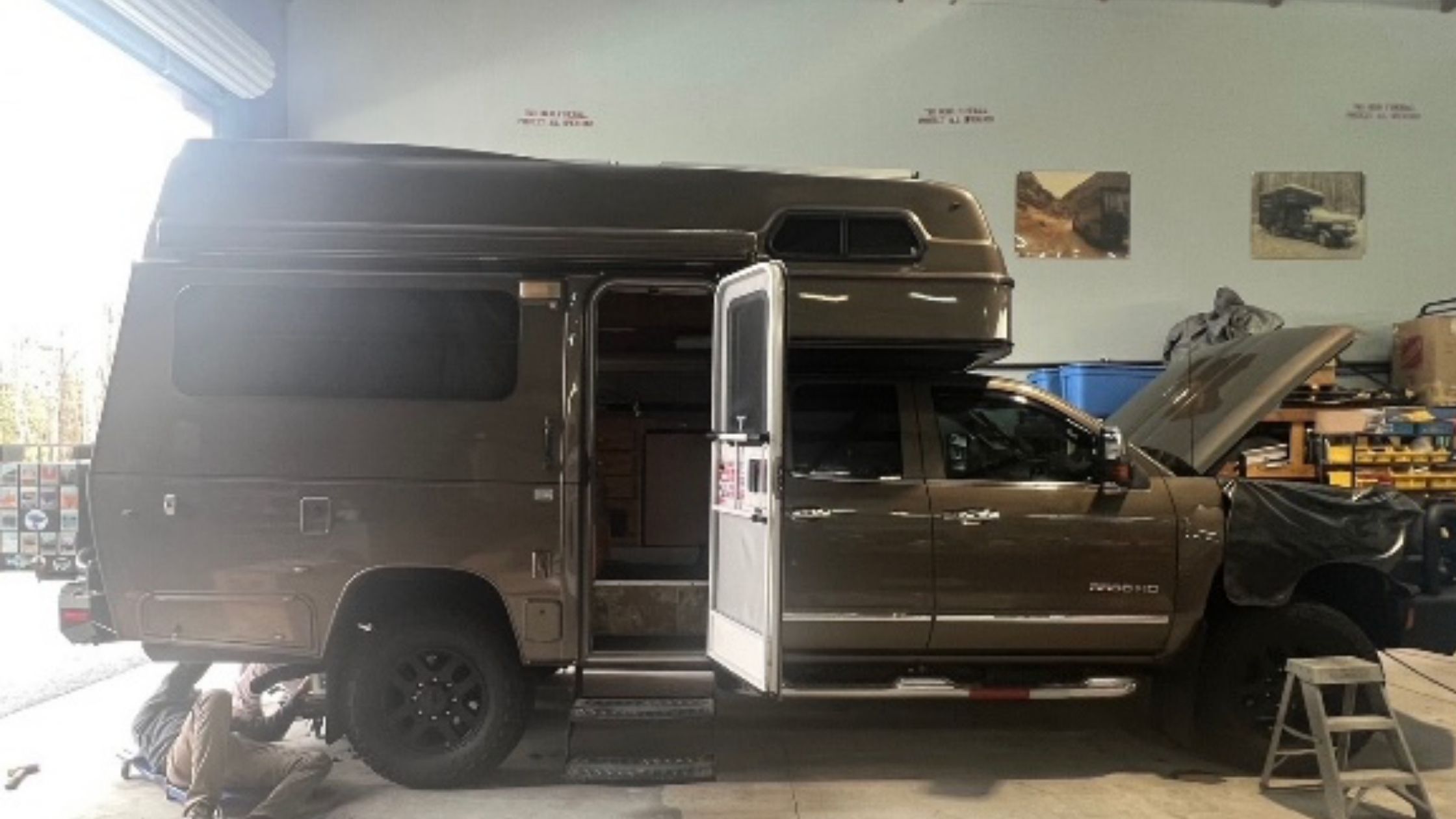 repair-service-and-parts-main-1 | Tiger Adventure Vehicles | Tiger Adventure Vehicles Brown Tiger RV on truck chassis being serviced in garage