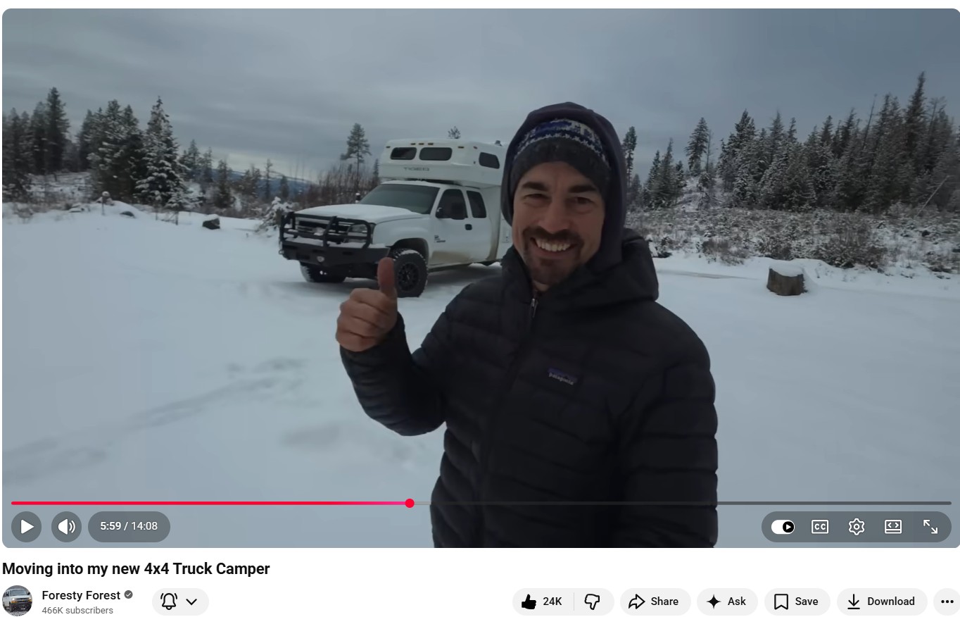 Man giving thumbs up in front of white Tiger truck camper in snowy winter landscape - YouTube video thumbnail