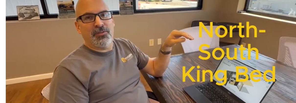 King Bed | Tiger Adventure Vehicles Video thumbnail: man at a table in an office discussing a North-South King Bed configuration for Tiger Adventure Vehicles.