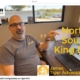 Video thumbnail: man at a table in an office discussing a North-South King Bed configuration for Tiger Adventure Vehicles.