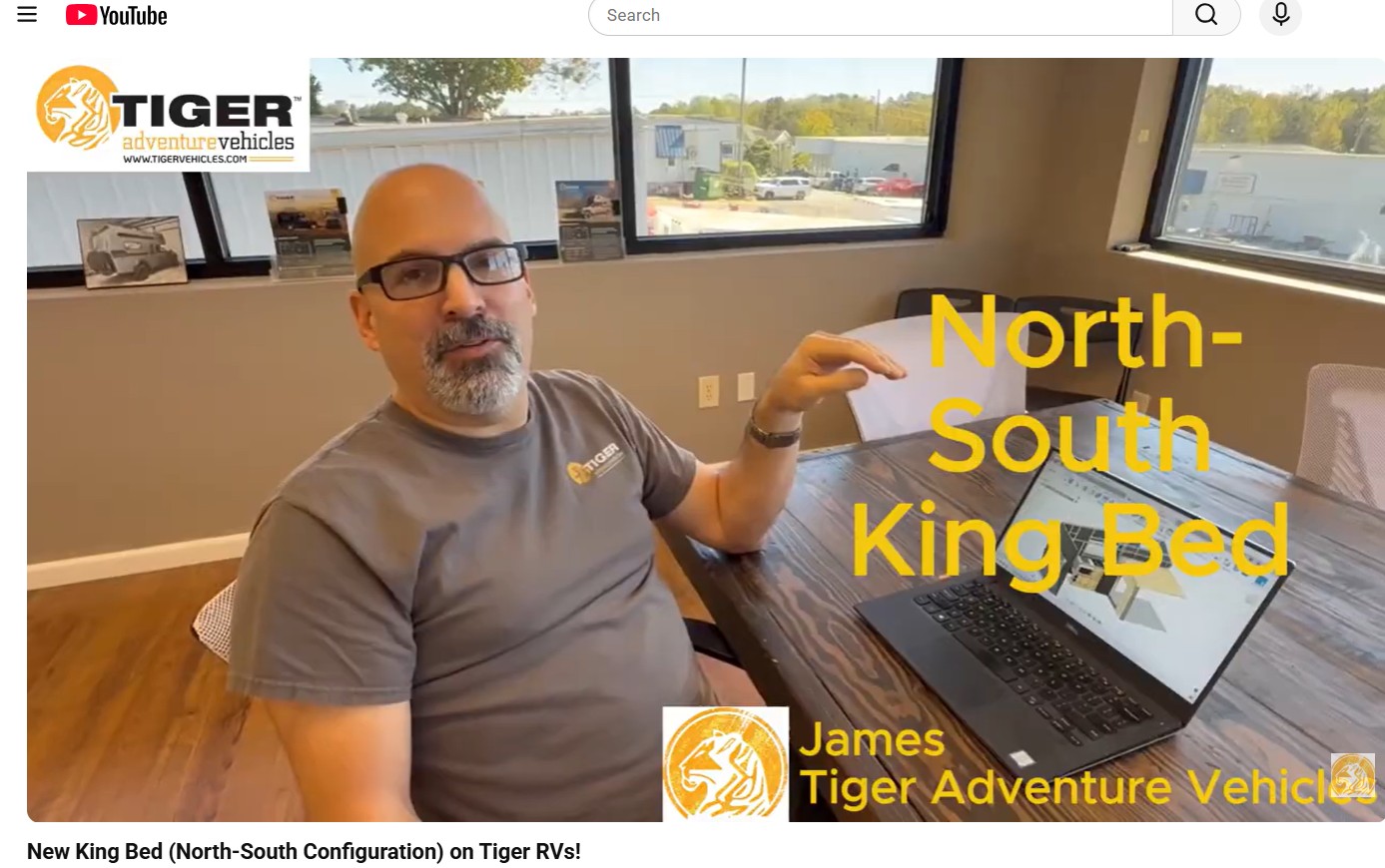 King Bed | Tiger Adventure Vehicles | Tiger Adventure Vehicles Video thumbnail: man at a table in an office discussing a North-South King Bed configuration for Tiger Adventure Vehicles.