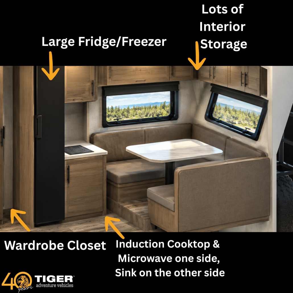 3 | Tiger Adventure Vehicles Interior of an RV living area: large fridge/freezer, lots of interior storage, wardrobe closet, induction cooktop and microwave area visible